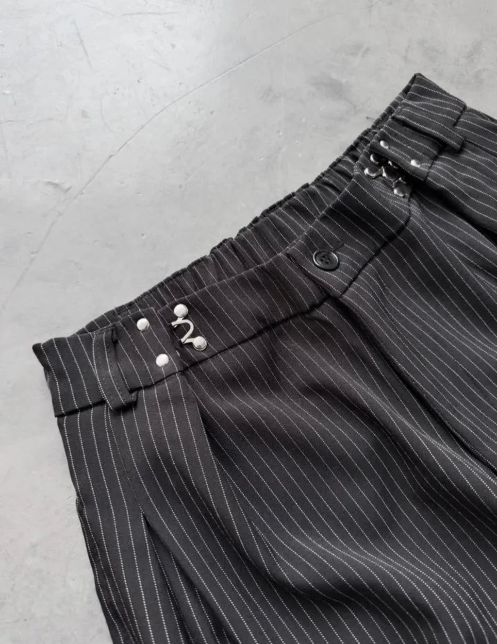 pinstripe trousers combine classic tailoring with modern streetwear elements