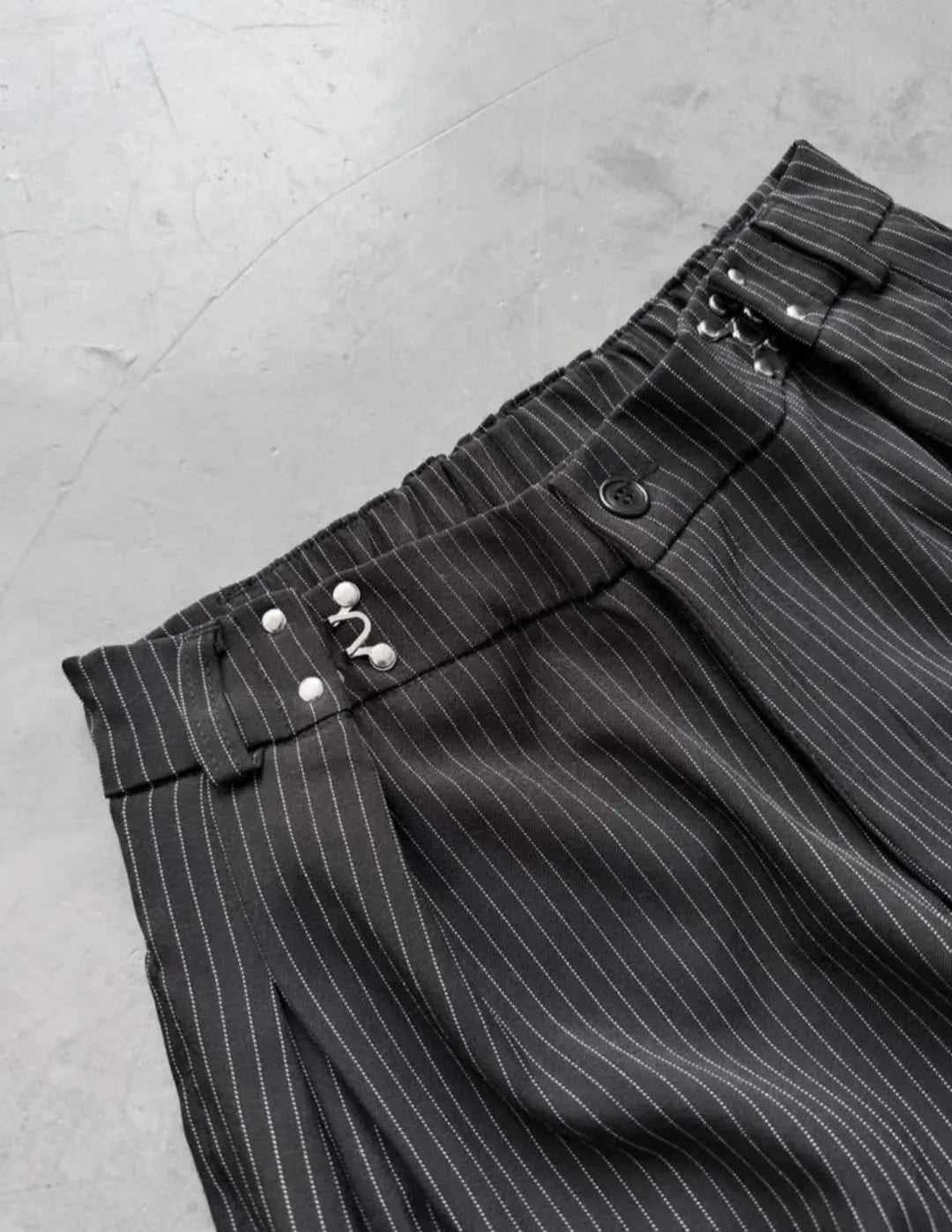 pinstripe trousers combine classic tailoring with modern streetwear elements