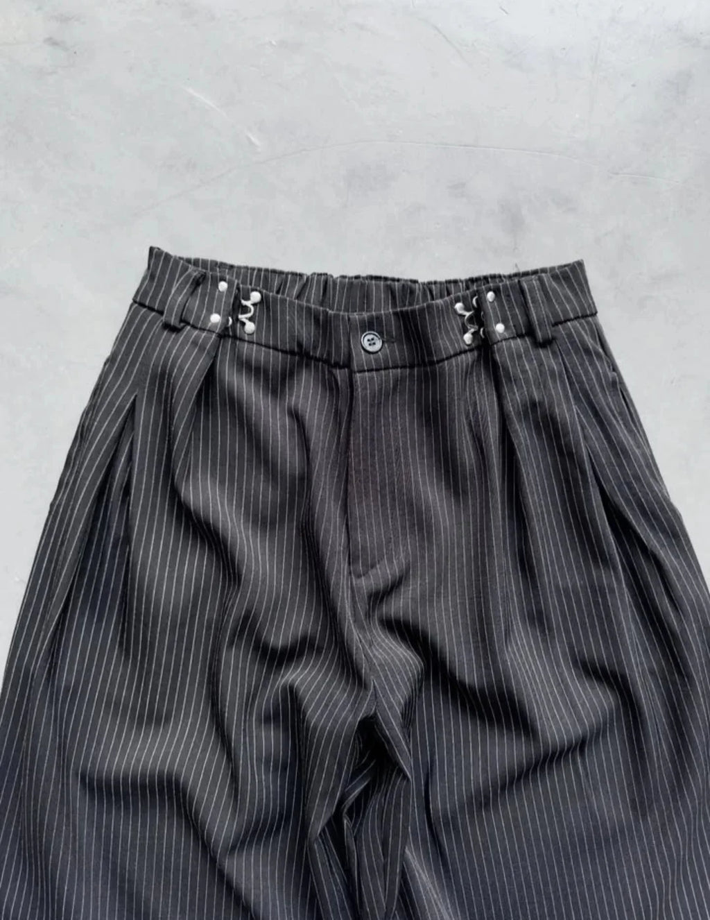 pinstripe trousers combine classic tailoring with modern streetwear elements