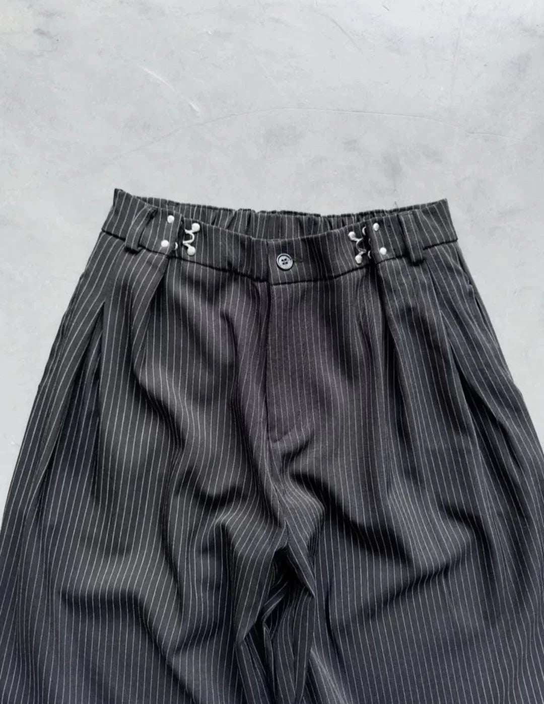 pinstripe trousers combine classic tailoring with modern streetwear elements