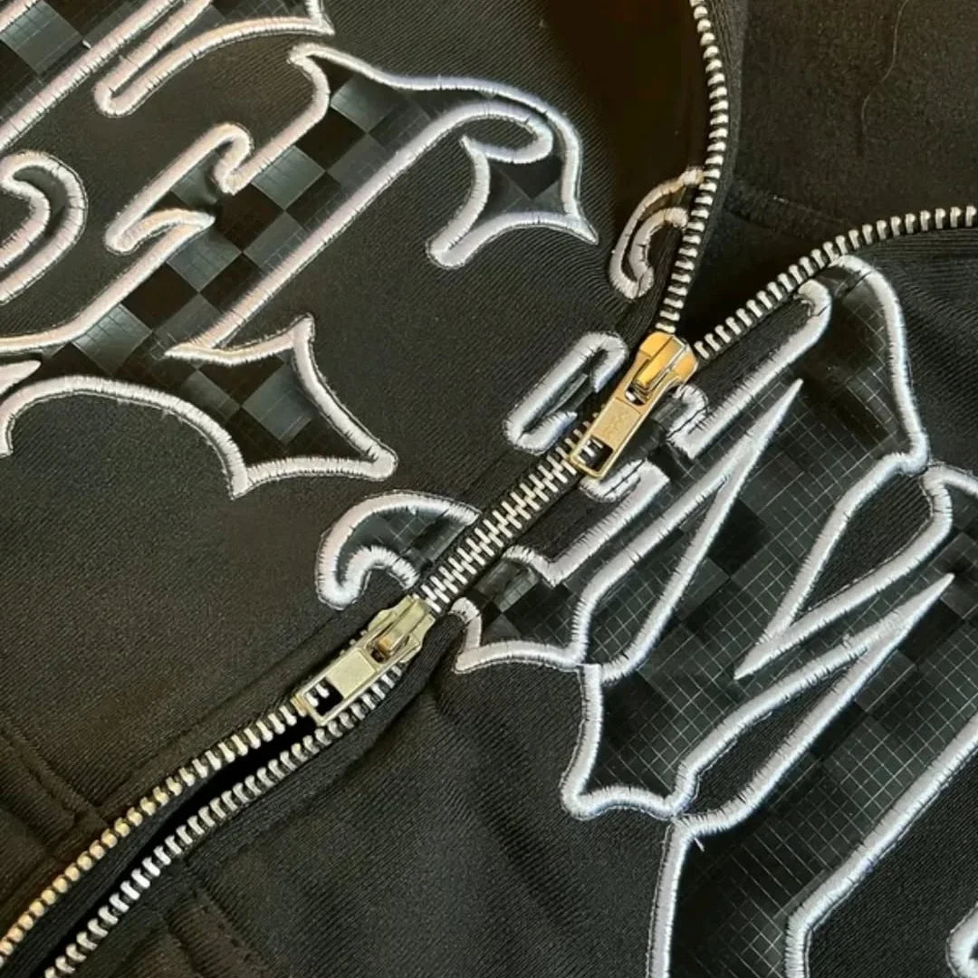 boxy-fit, black zip-up hoodie featuring Gothic/Old English style lettering