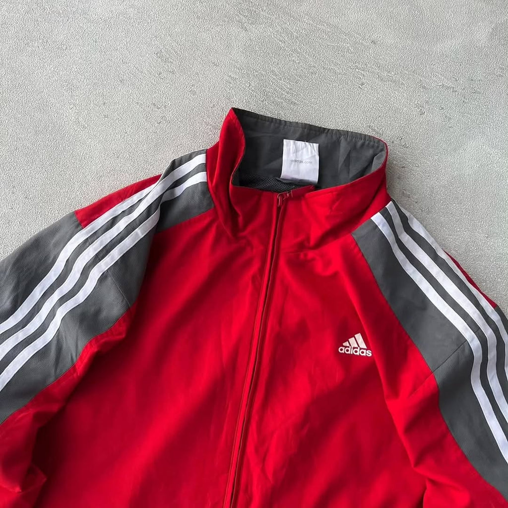 Adidas track jacket with a bold, two-tone athletic design
