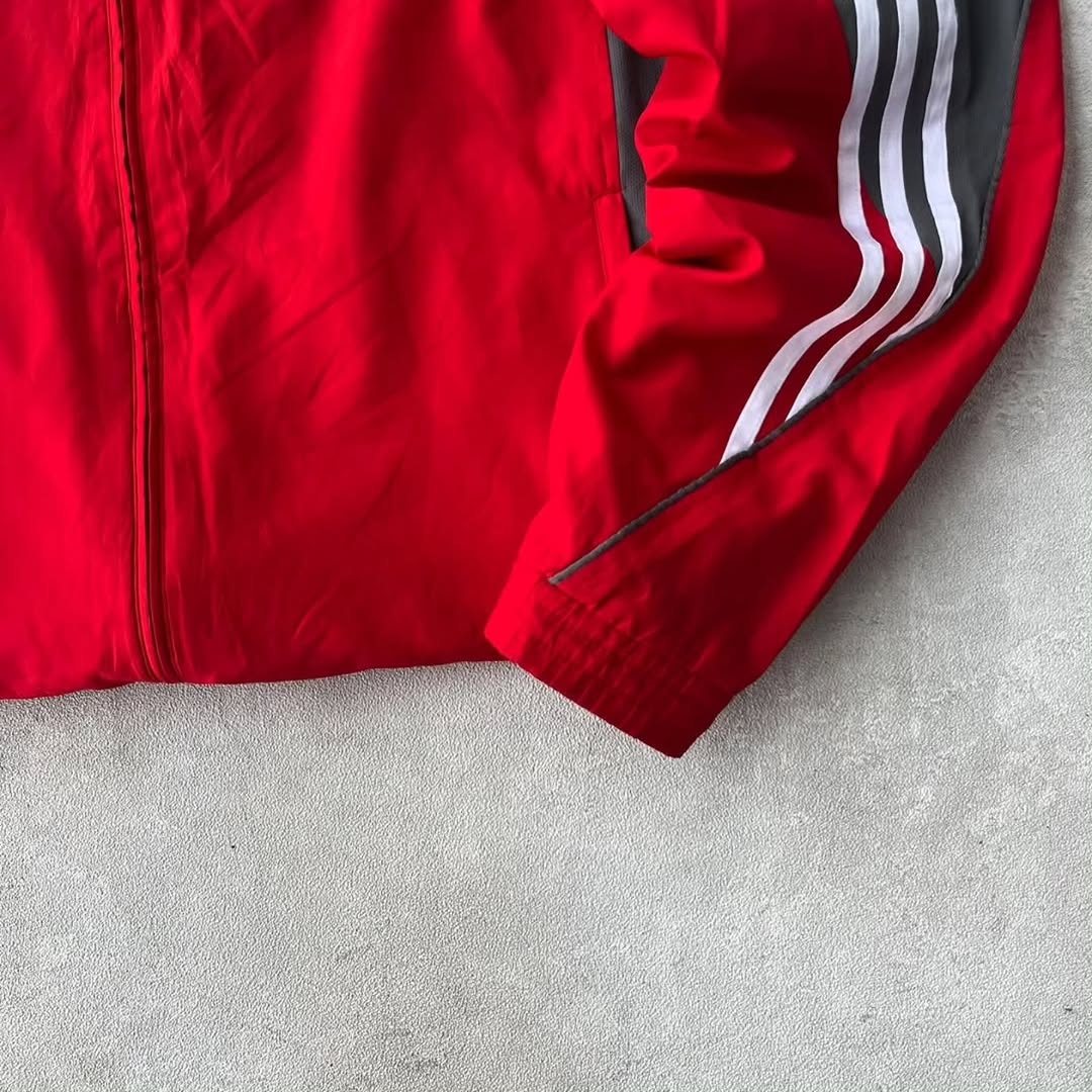 Adidas track jacket with a bold, two-tone athletic design