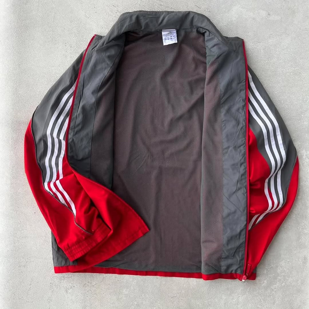 Adidas track jacket with a bold, two-tone athletic design