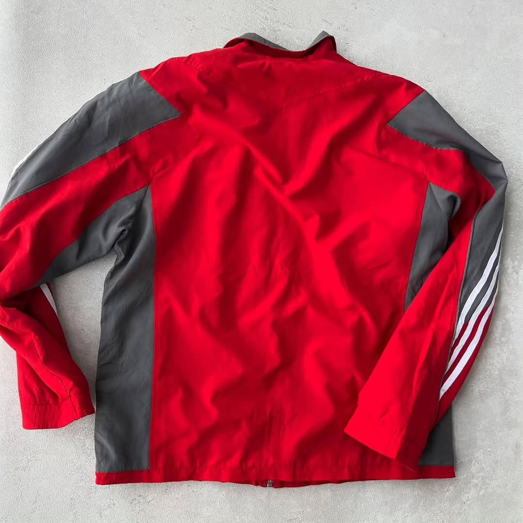Adidas track jacket with a bold, two-tone athletic design